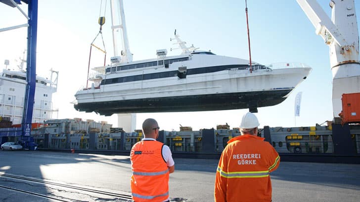 Luxury yacht being transported on specialized marine carrier